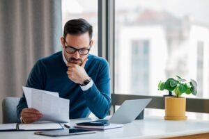 man stares at insurance policy